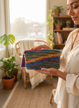 Load image into Gallery viewer, Woman holding colorful crochet pouch lifestyle shot
