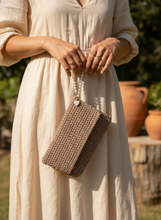 Load image into Gallery viewer, Woman holding crochet clutch lifestyle image
