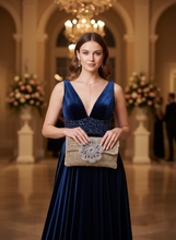 Load image into Gallery viewer, Woman holding gold clutch - full view with flower
