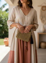 Load image into Gallery viewer, Woman Holding Raffia Crochet Pouch - Lifestyle Image
