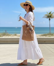 Load image into Gallery viewer, Woman holding raffia summer bag
