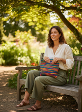 Load image into Gallery viewer, Woman with multicolored crochet bag outdoors
